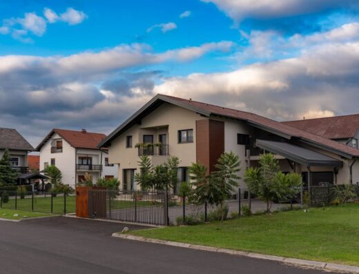 Contemporary homes in Garešnica, Croatia featuring lush gardens and dramatic sky.